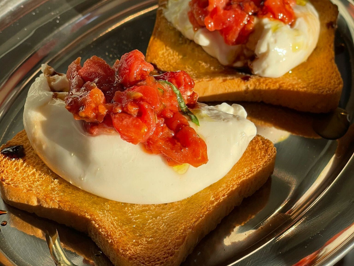 Crostini with Burrella, Tomato Tartare, Fresh Basil, Oregano, Balsamic Glaze and EVOO.